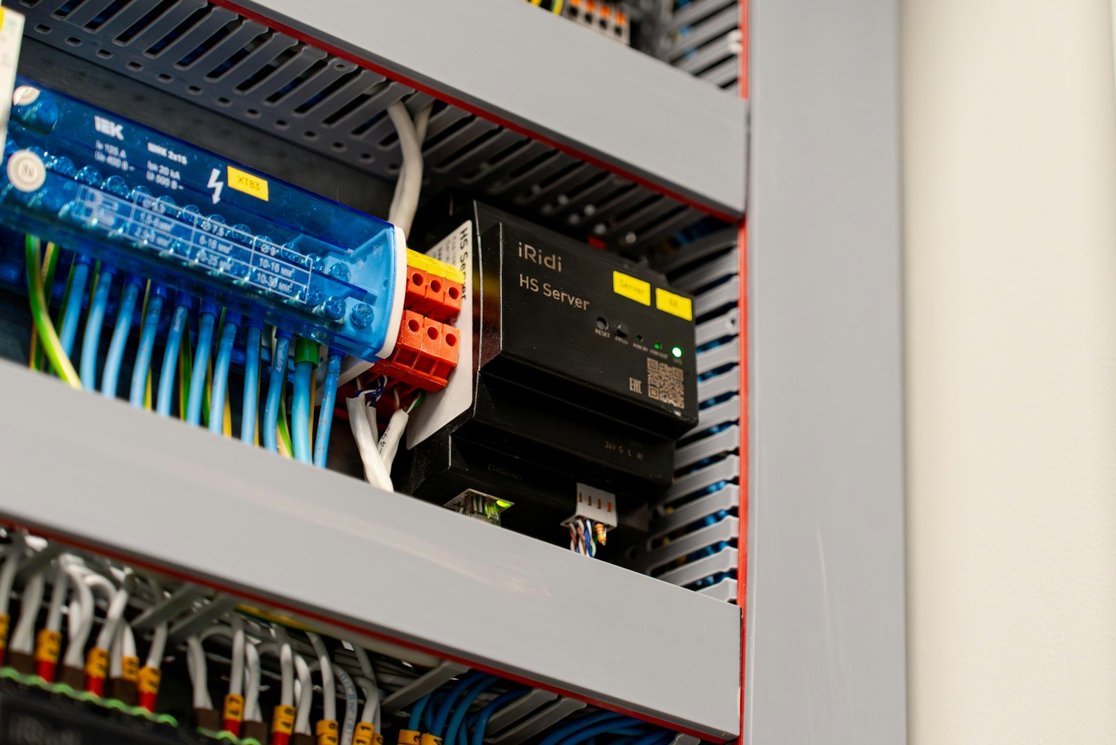 A modular industrial controller and terminal blocks wired inside a panel